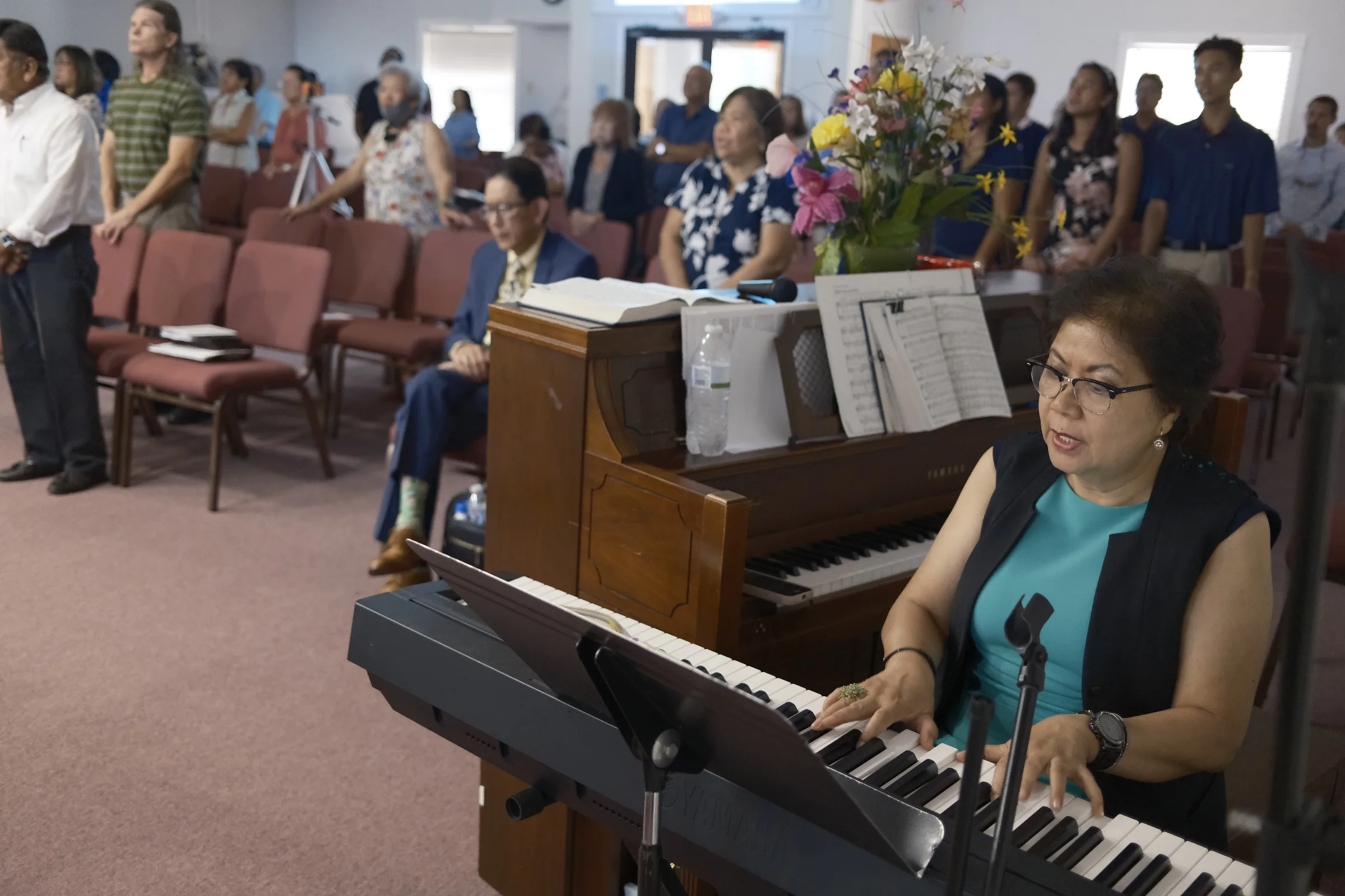 Mornie Roxas plays piano during the worship service